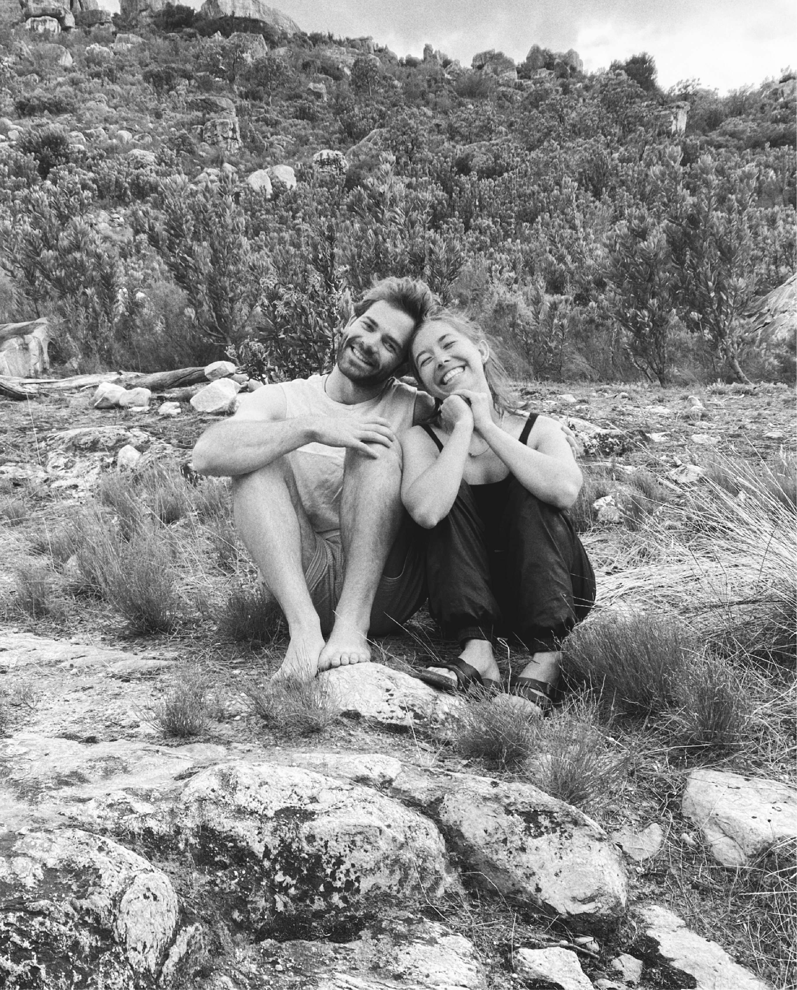 Cribba and Jantie sitting on rocks in the mountains